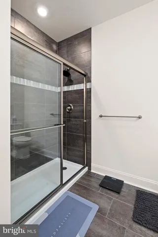 a bathroom with a glass shower door
