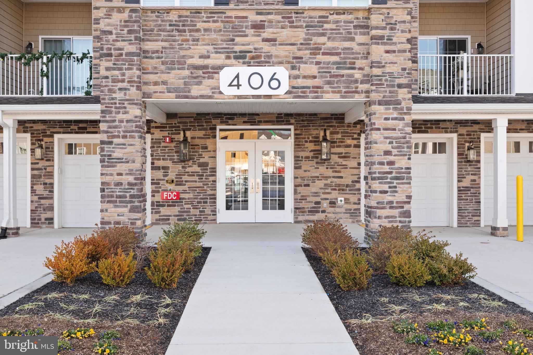 406 Bold Ruler Court, Unit 207 Havre de Grace, MD 21078 - Photo 3 of 57 a front view of a building with potted plants