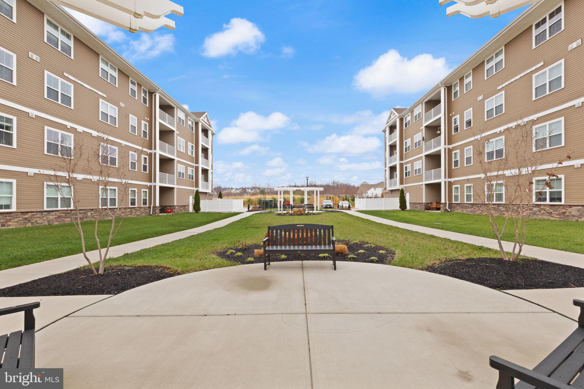 406 Bold Ruler Court, Unit 207 Havre de Grace, MD 21078 - Photo 31 of 57 a view of a building with a garden