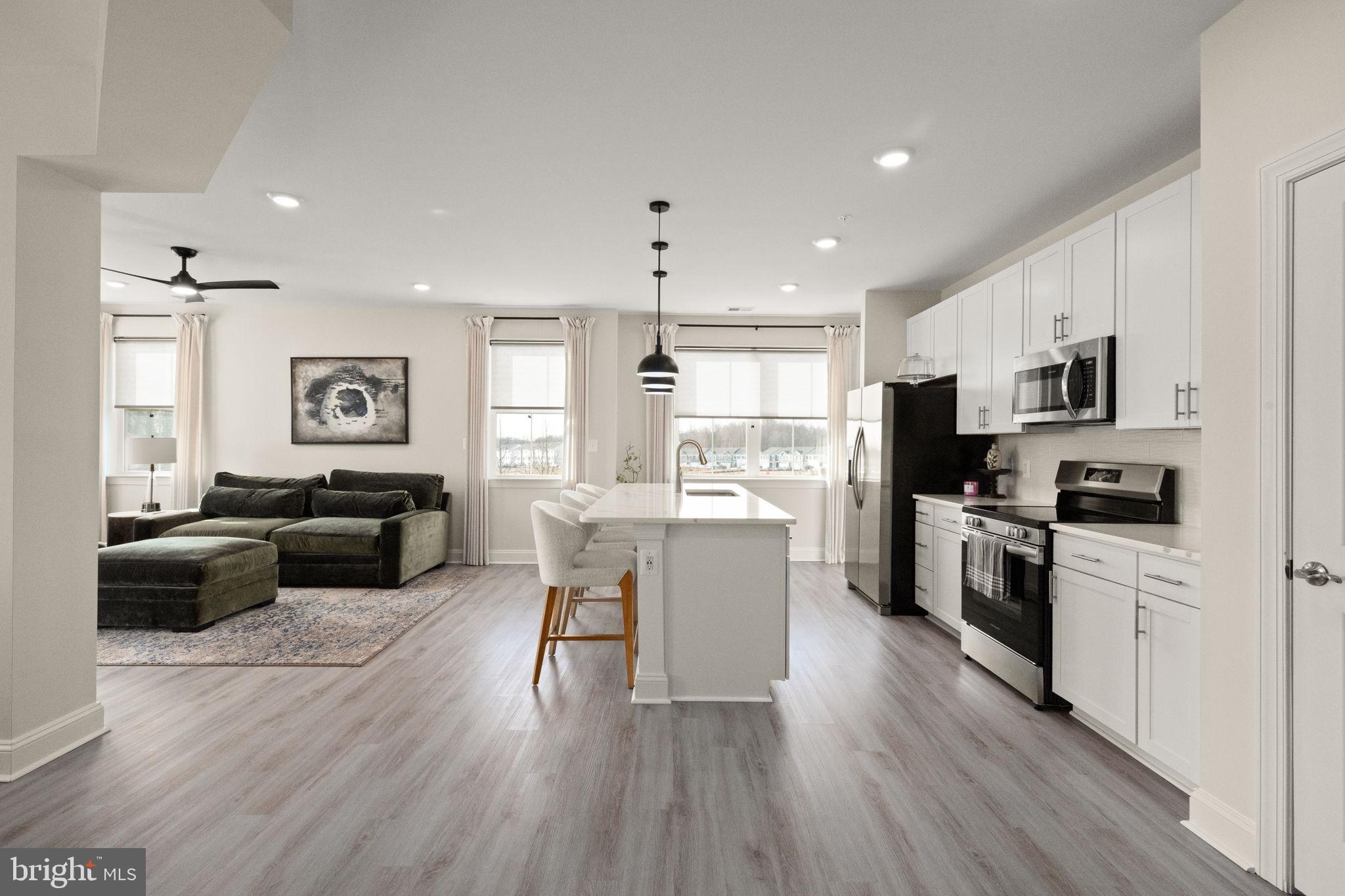 406 Bold Ruler Court, Unit 207 Havre de Grace, MD 21078 - Photo 4 of 57 a kitchen with a refrigerator cabinets and wooden floor