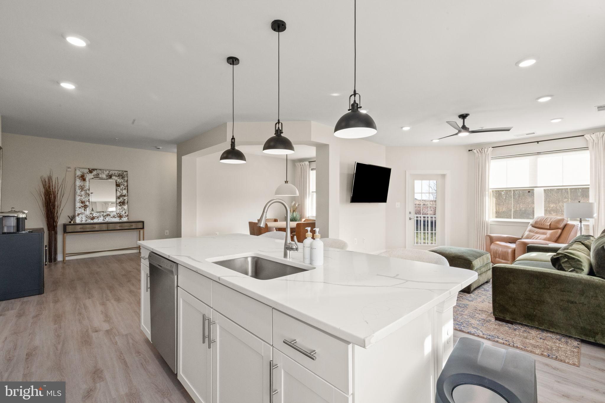 406 Bold Ruler Court, Unit 207 Havre de Grace, MD 21078 - Photo 5 of 57 a kitchen with sink refrigerator and microwave
