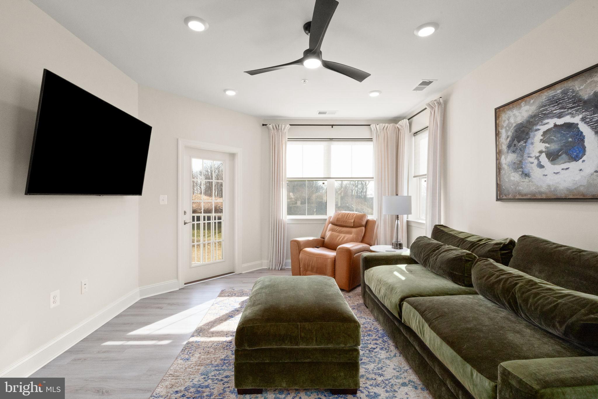 406 Bold Ruler Court, Unit 207 Havre de Grace, MD 21078 - Photo 7 of 57 a living room with furniture and a flat screen tv
