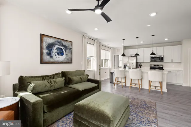 a living room with furniture and kitchen view