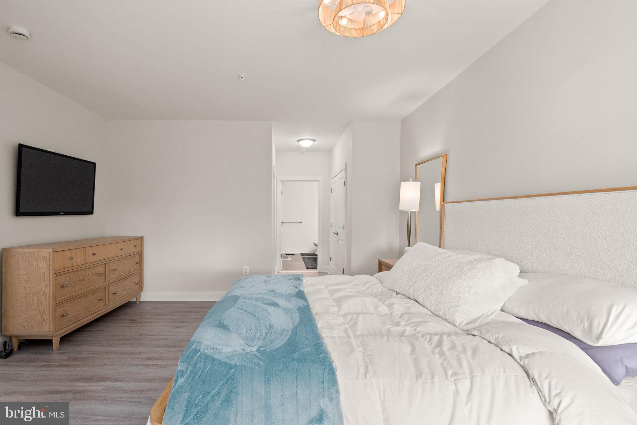 406 Bold Ruler Court, Unit 207 Havre de Grace, MD 21078 - Photo 10 of 57 a bedroom with a bed and a flat screen tv