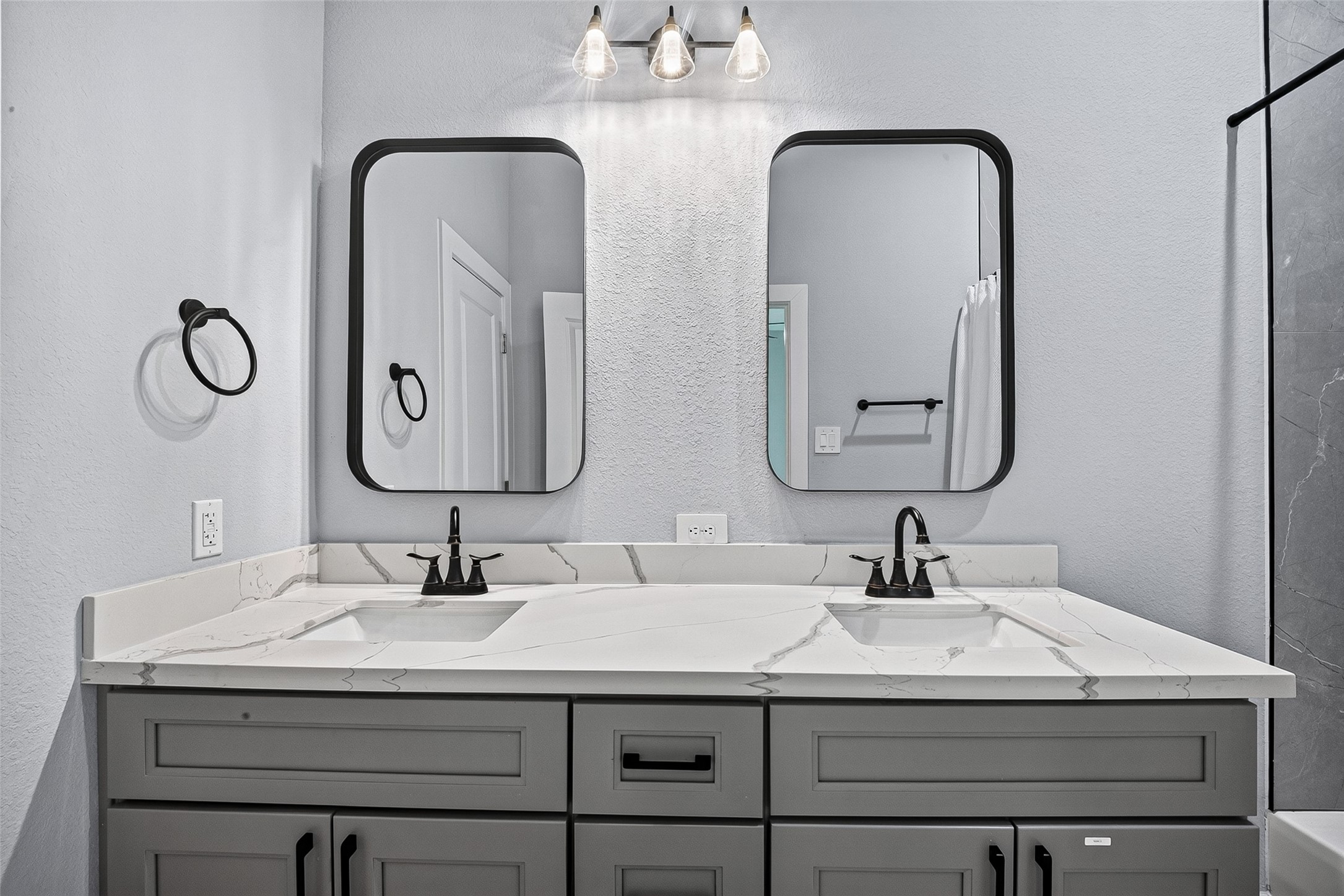 5027 Dickens Road, Unit B Houston, TX 77021 - Photo 18 of 24 Dual-sink vanity with Calacatta-style quartz countertop and dark-finish fixtures.
