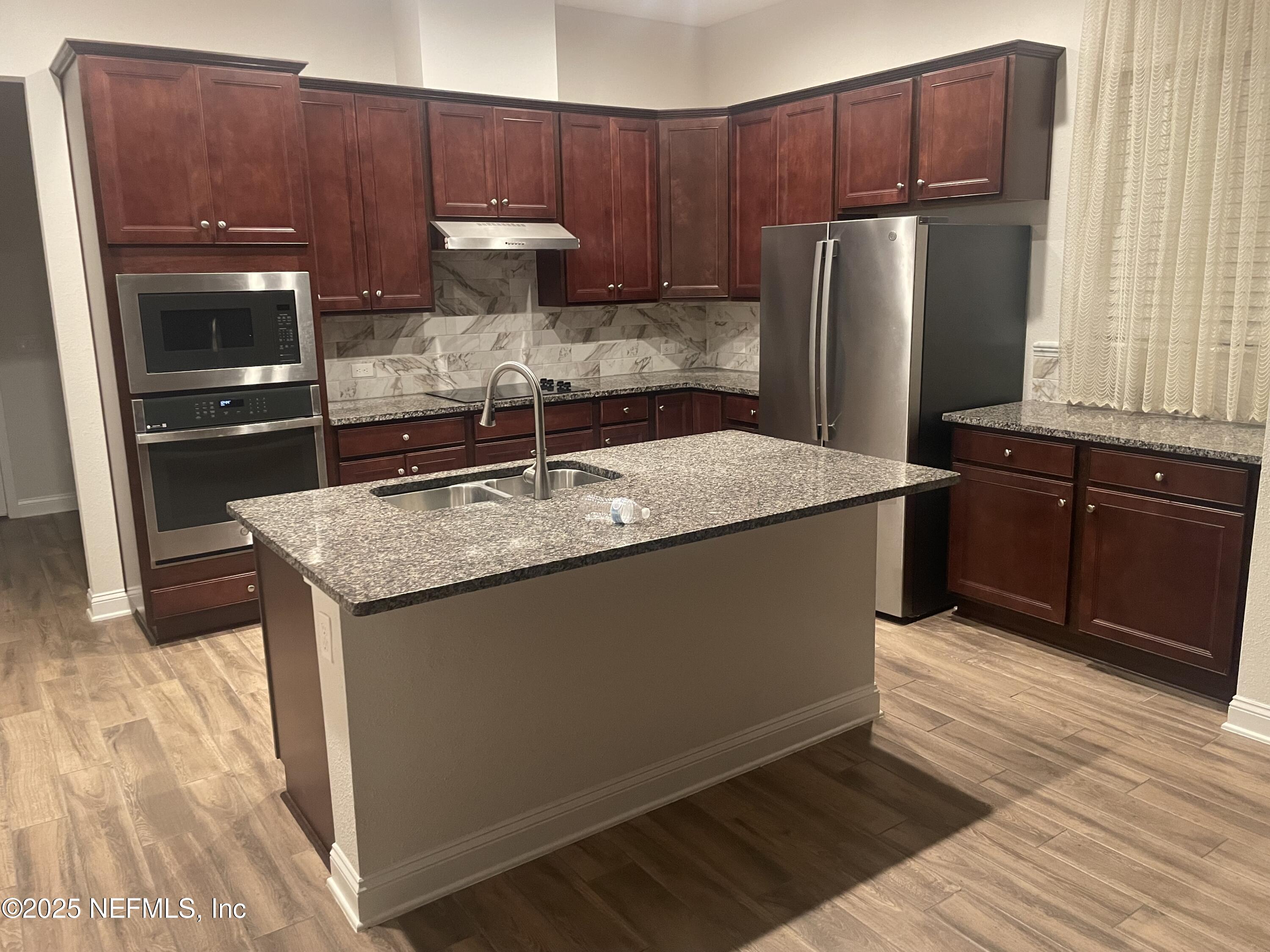 2489 Caprera Circle Jacksonville, FL 32246 - Photo 5 of 30 a kitchen with stainless steel appliances granite countertop a refrigerator a sink and a stove