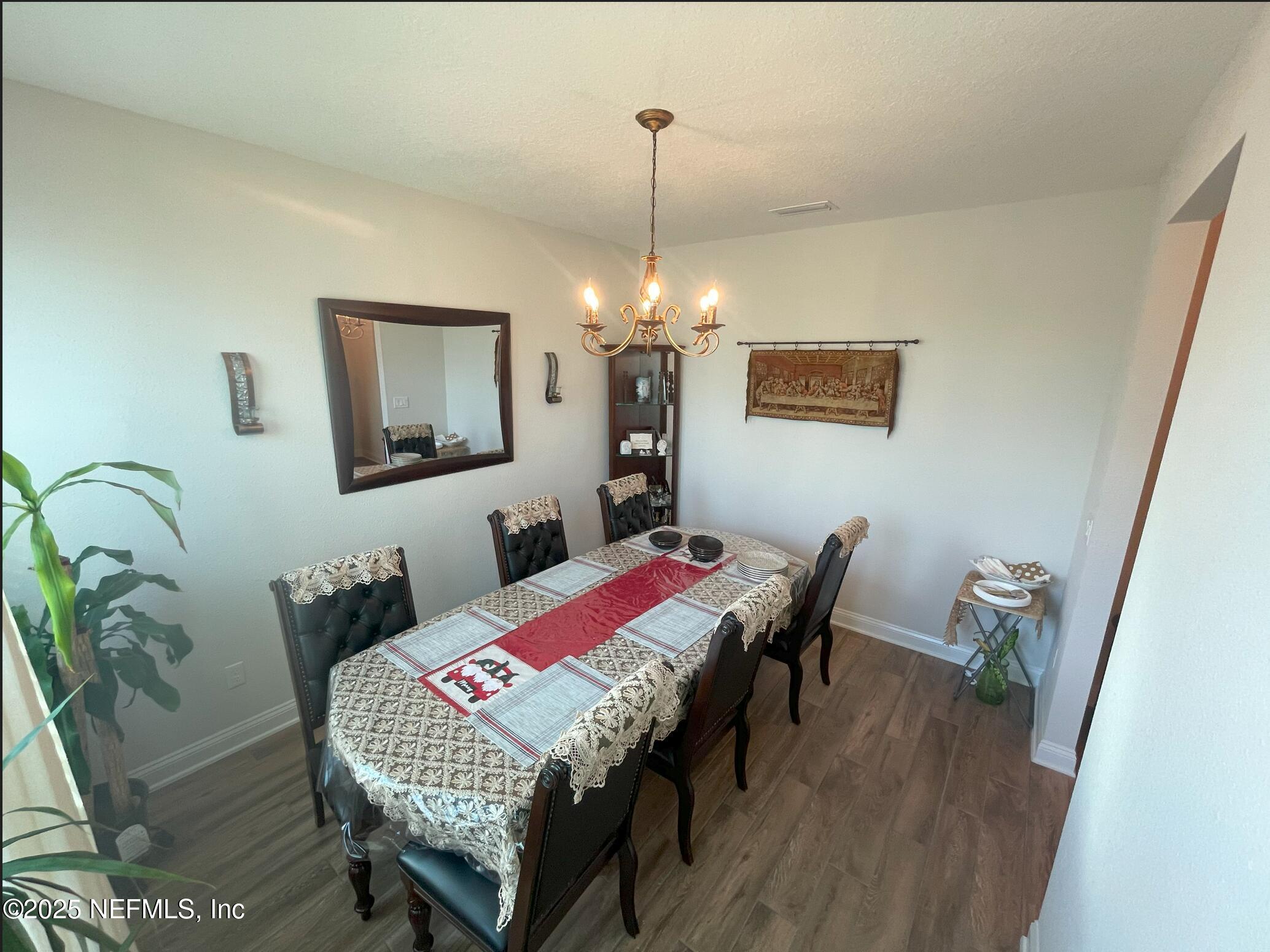 2489 Caprera Circle Jacksonville, FL 32246 - Photo 7 of 30 a view of a dining room with furniture and wooden floor