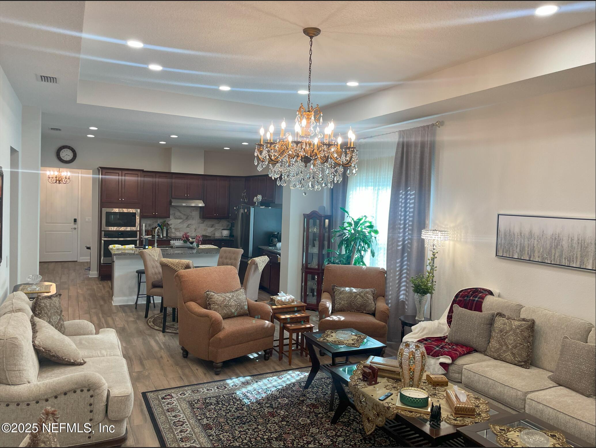 2489 Caprera Circle Jacksonville, FL 32246 - Photo 9 of 30 a living room with furniture and a chandelier