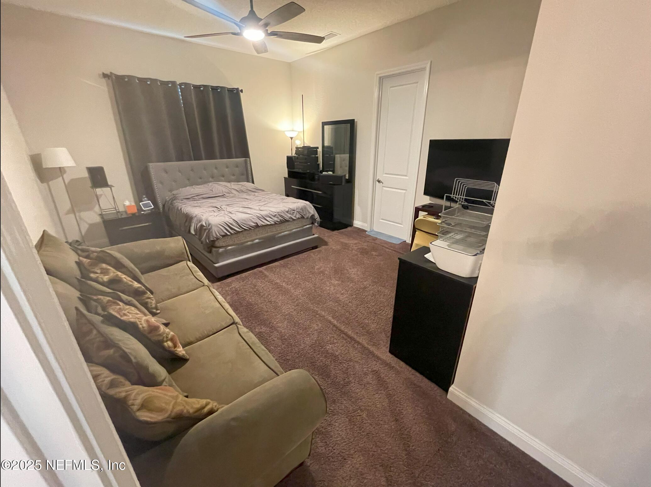 2489 Caprera Circle Jacksonville, FL 32246 - Photo 10 of 30 a bedroom with furniture and a bed