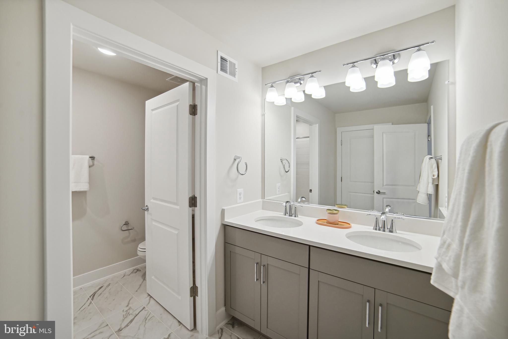 8065 Jennys Way Fulton, MD 20759 - Photo 12 of 17 a bathroom with a double vanity sink mirror and shower