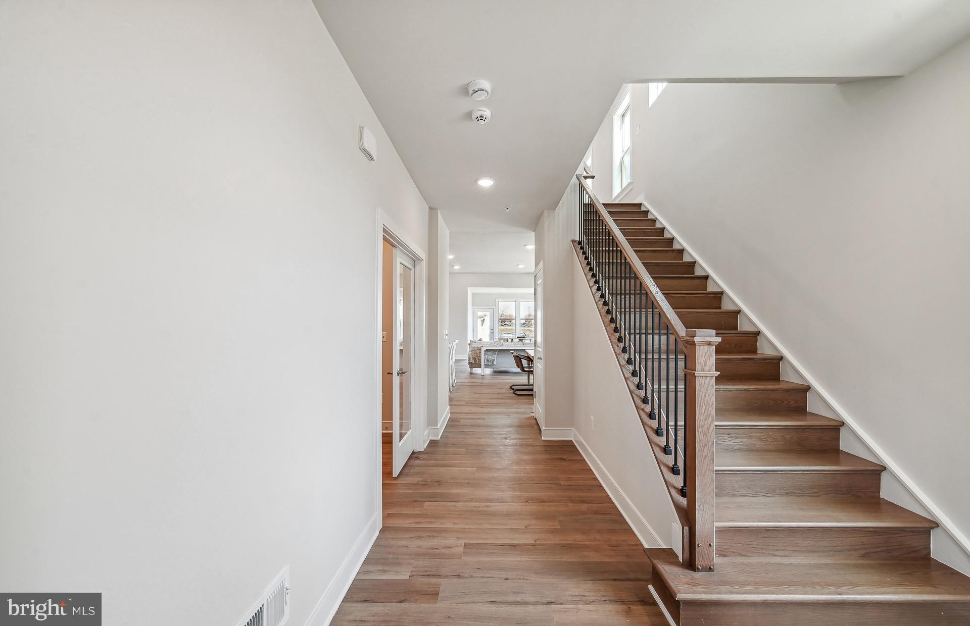 8065 Jennys Way Fulton, MD 20759 - Photo 2 of 17 a view of a hallway with wooden floor and entryway