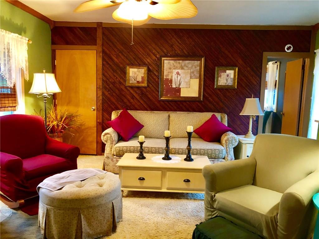 650 Shaffer Road Hookstown, PA 15050 - Photo 2 of 25 LIVING ROOM 16x15 The Living Room spans the width of the house. Rich decorative wood accent wall with large coat/storage closet on left. Open door to Master Bedroom. Wall to wall carpet and ceiling fan.