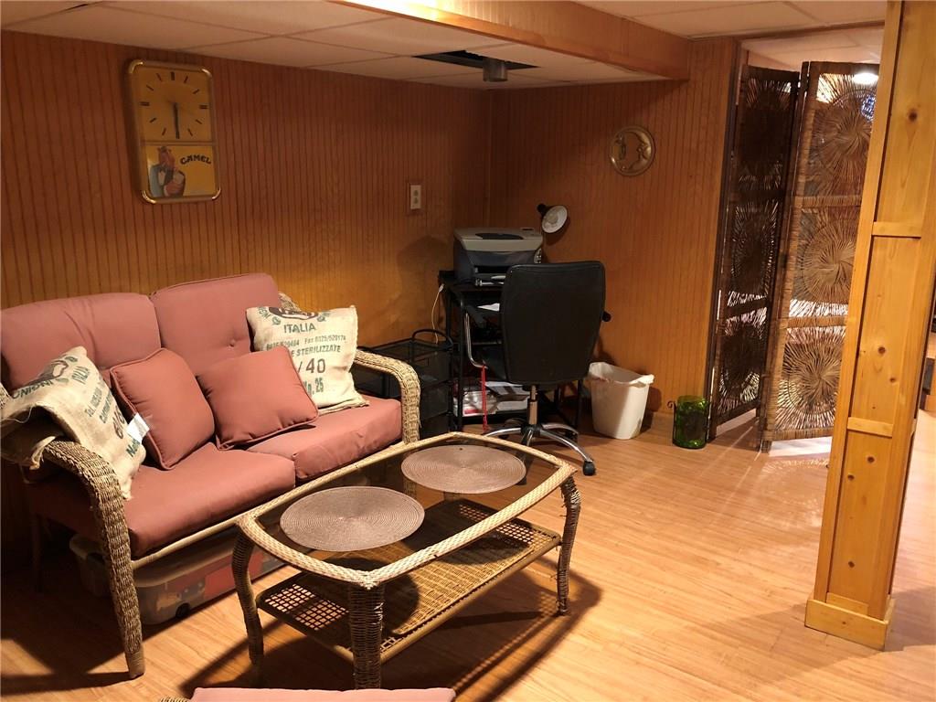 650 Shaffer Road Hookstown, PA 15050 - Photo 18 of 25 DEN 14x12 Located on the lower level just outside the Bedroom area. Currently uses as a sitting and office area. Vertically installed wood wainscoting on the walls and laminate wood look floors. Chicago grid ceiling.
