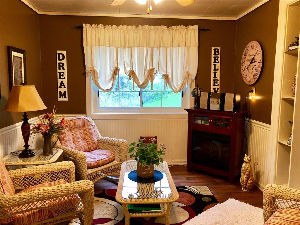 650 Shaffer Road Hookstown, PA 15050 - Photo 5 of 25 DINING ROOM 12x10 The Dining Room is located directly off the Kitchen and is currently being used as a Sitting Area. Newer wood look vinyl floor and painted wood trim around windows and doors. Decorative wood wainscoting on the walls and a ceiling fan.