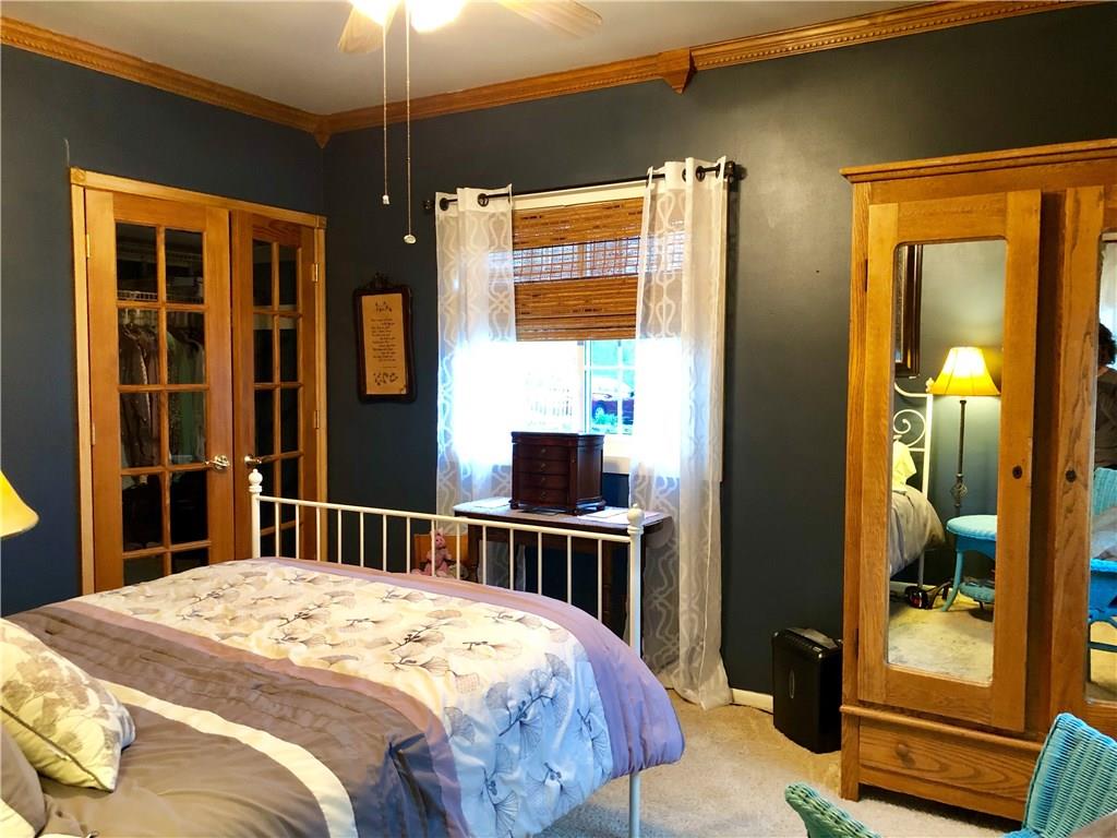 650 Shaffer Road Hookstown, PA 15050 - Photo 10 of 25 Another view of the Master Bedroom showing the mirrored armoire that stays with the home and the decorative French doors leading to the spacious closet.