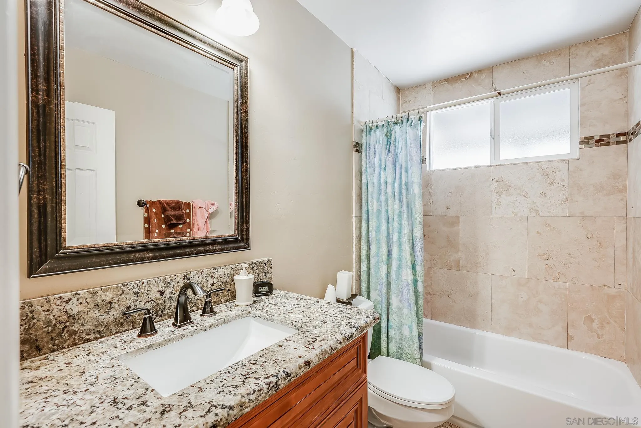 13902 Powers Road Poway, CA 92064 - Photo 20 of 32 a bathroom with a granite countertop sink toilet mirror and shower