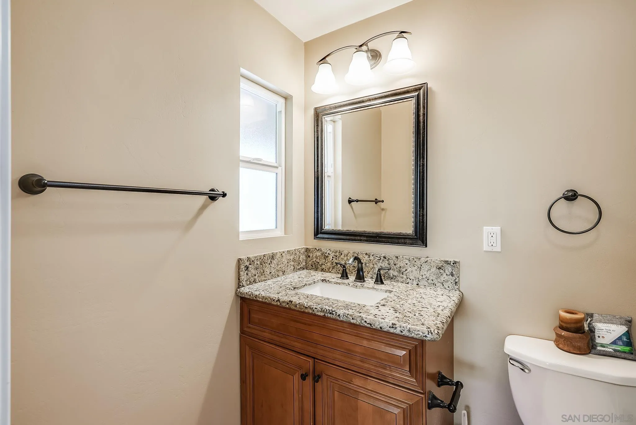 13902 Powers Road Poway, CA 92064 - Photo 31 of 32 a bathroom with a granite countertop sink toilet and a mirror