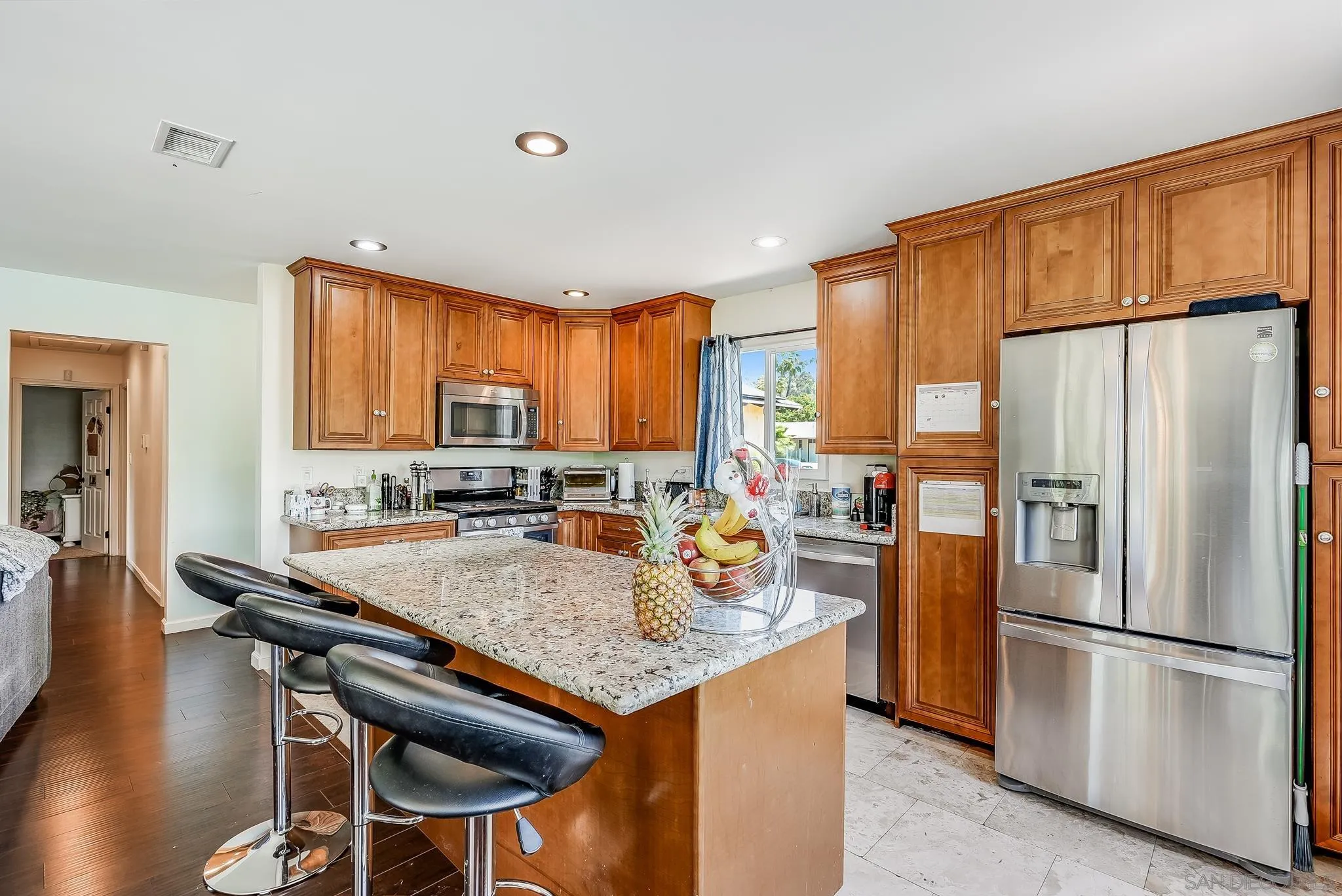 13902 Powers Road Poway, CA 92064 - Photo 10 of 32 a kitchen with stainless steel appliances granite countertop a refrigerator a stove a sink a table and chairs
