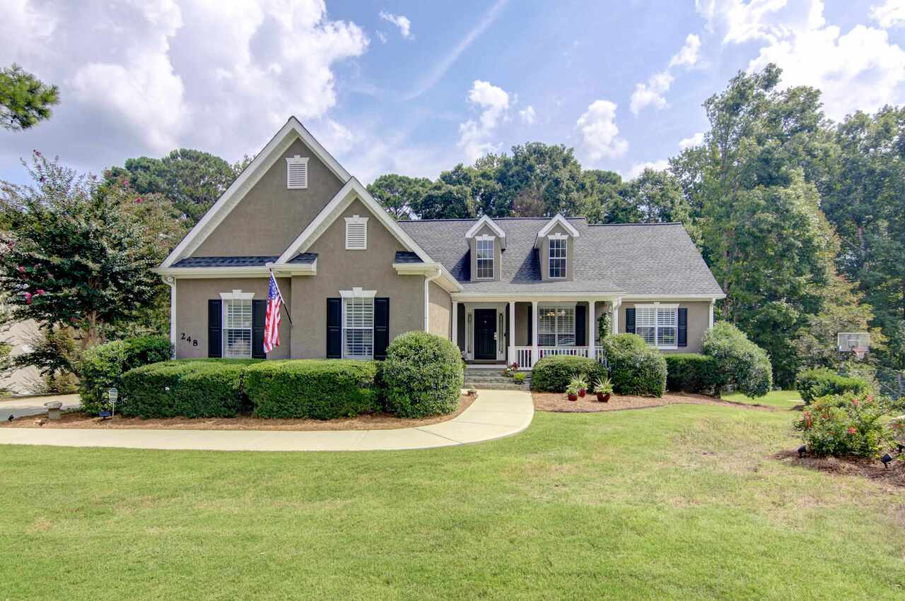 248 Pheasant Ridge Newnan, GA 30265 - Photo 1 of 1 a front view of a house with a yard and potted plants