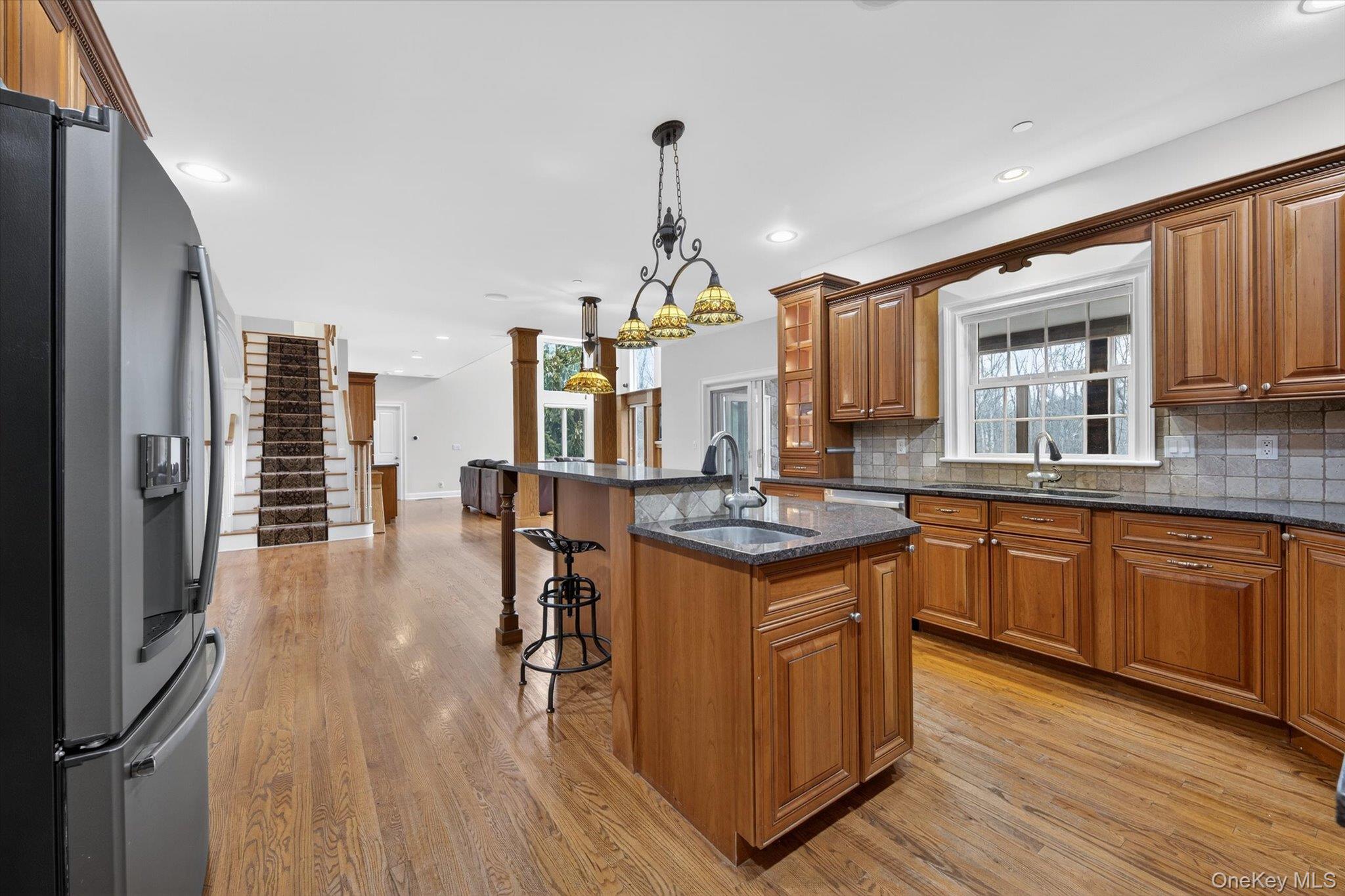 7 Farm Hollow Road New Windsor, NY 12553 - Photo 11 of 36 Kitchen featuring wood finish cabinetry, a kitchen breakfast bar, stainless steel refrigerator with ice dispenser, and dark stone countertops