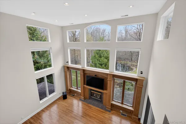 a dining room with wooden floor windows and entryway