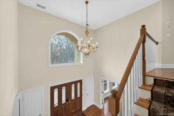 a view of a living room a wooden floor and windows