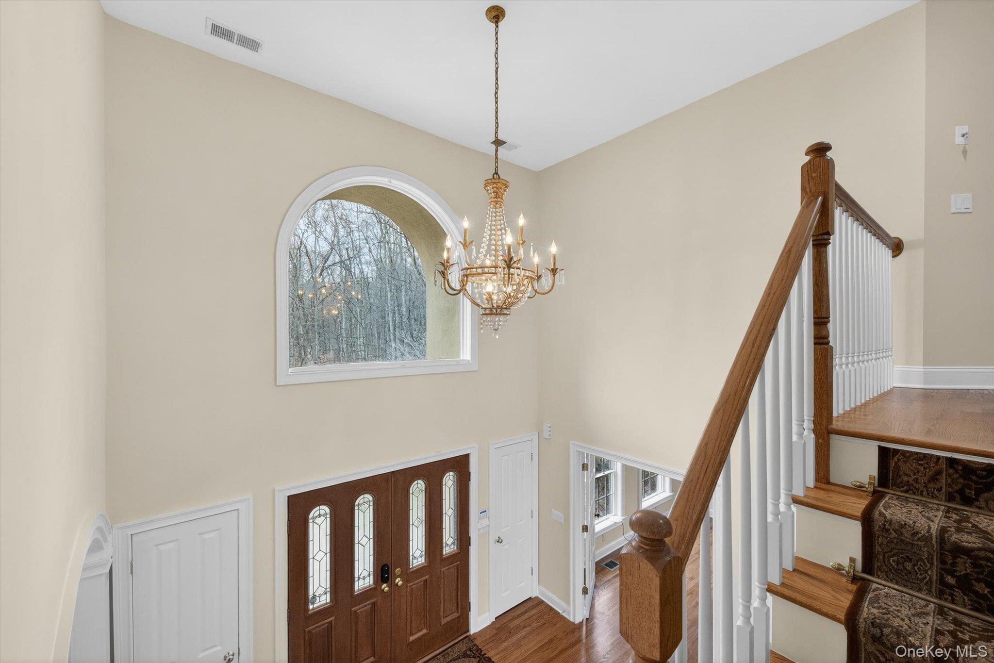 7 Farm Hollow Road New Windsor, NY 12553 - Photo 17 of 36 Entryway with a chandelier, plenty of natural light, dark wood finished floors, and a high ceiling