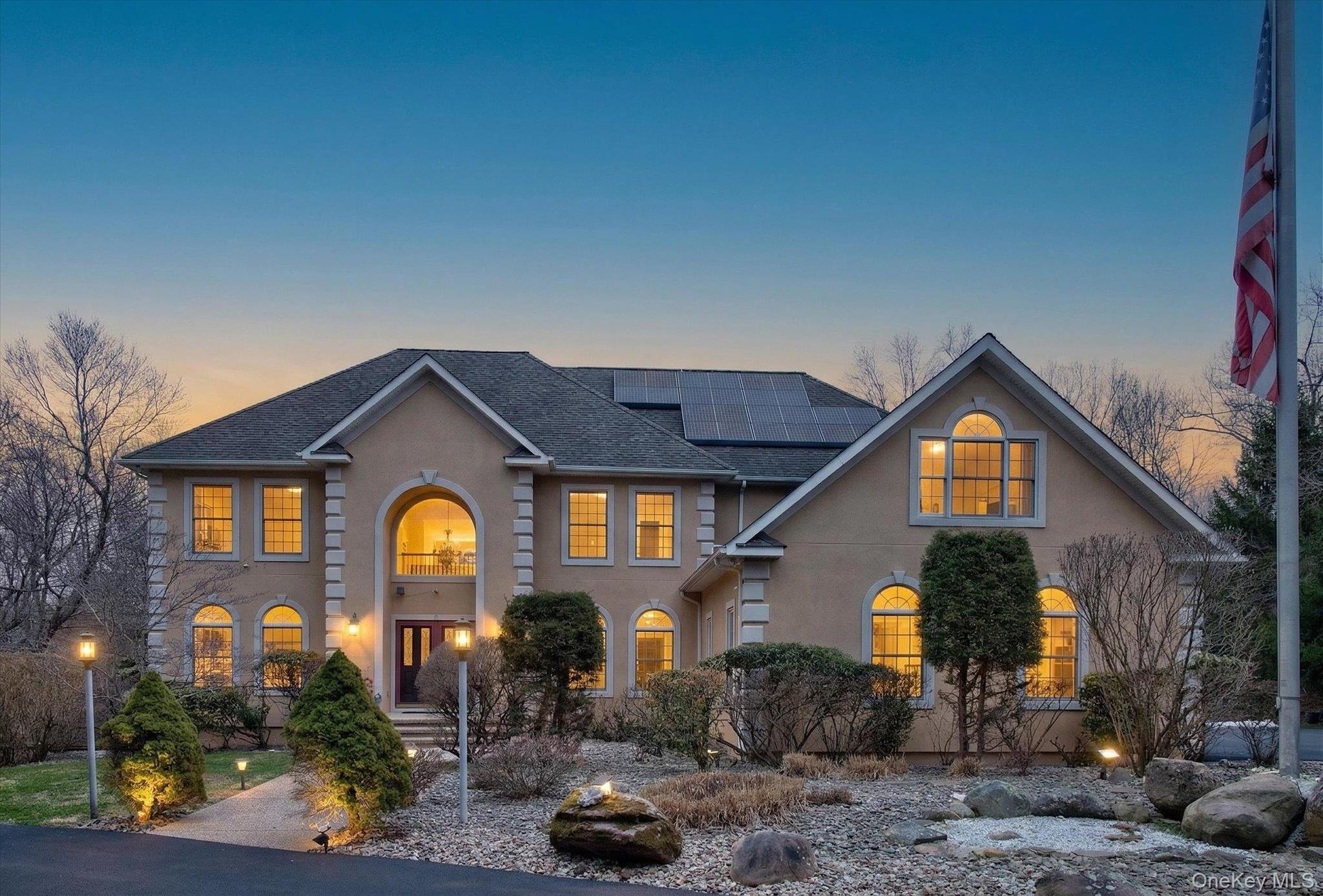 7 Farm Hollow Road New Windsor, NY 12553 - Photo 2 of 36 View of front of house with roof mounted solar panels and stucco siding