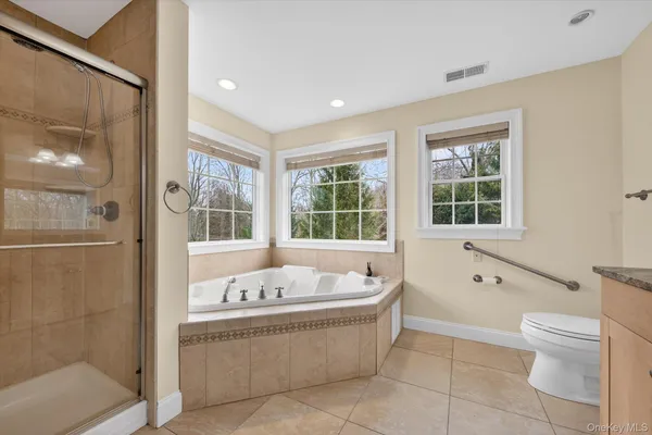 a bathroom with a granite countertop double vanity sink and a mirror