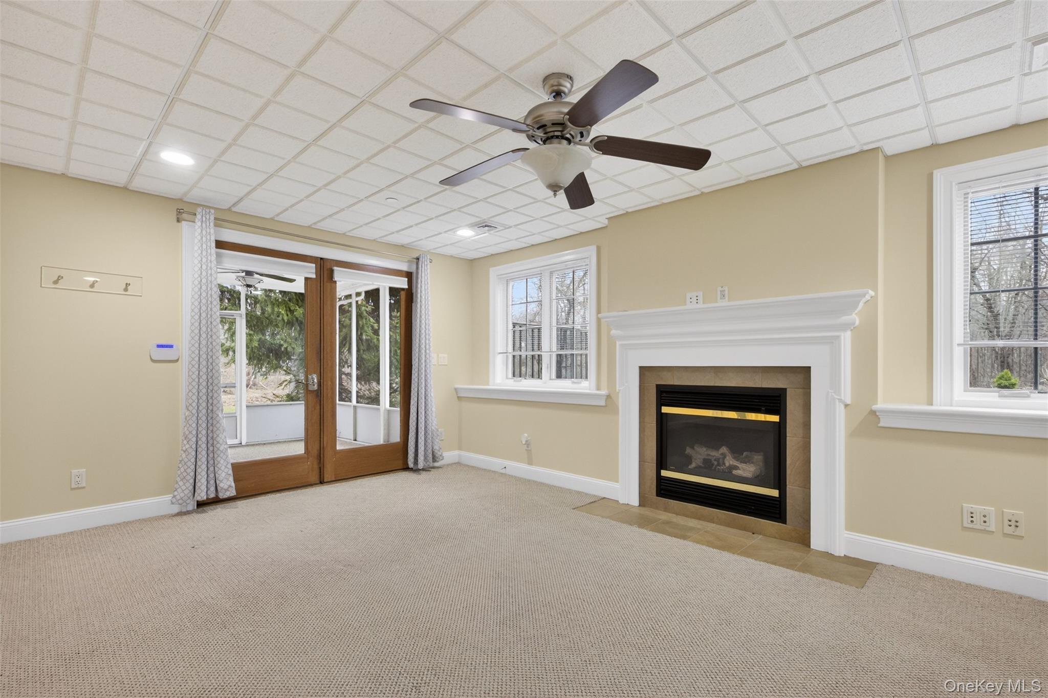 7 Farm Hollow Road New Windsor, NY 12553 - Photo 24 of 36 Unfurnished living room with a ceiling fan, light colored carpet, french doors, and a drop ceiling