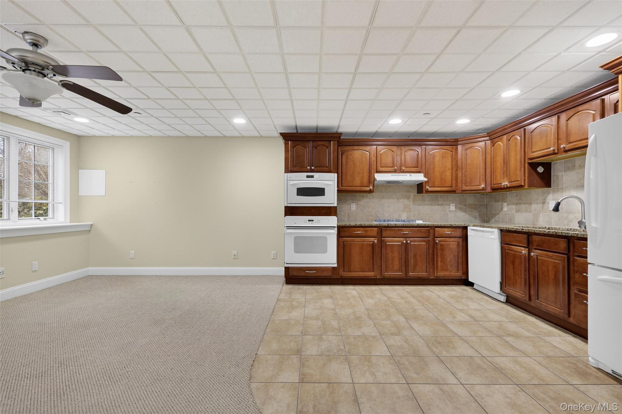 7 Farm Hollow Road New Windsor, NY 12553 - Photo 26 of 36 Kitchen featuring ceiling fan, light tile patterned floors, wood finish cabinetry, white appliances, and light carpet