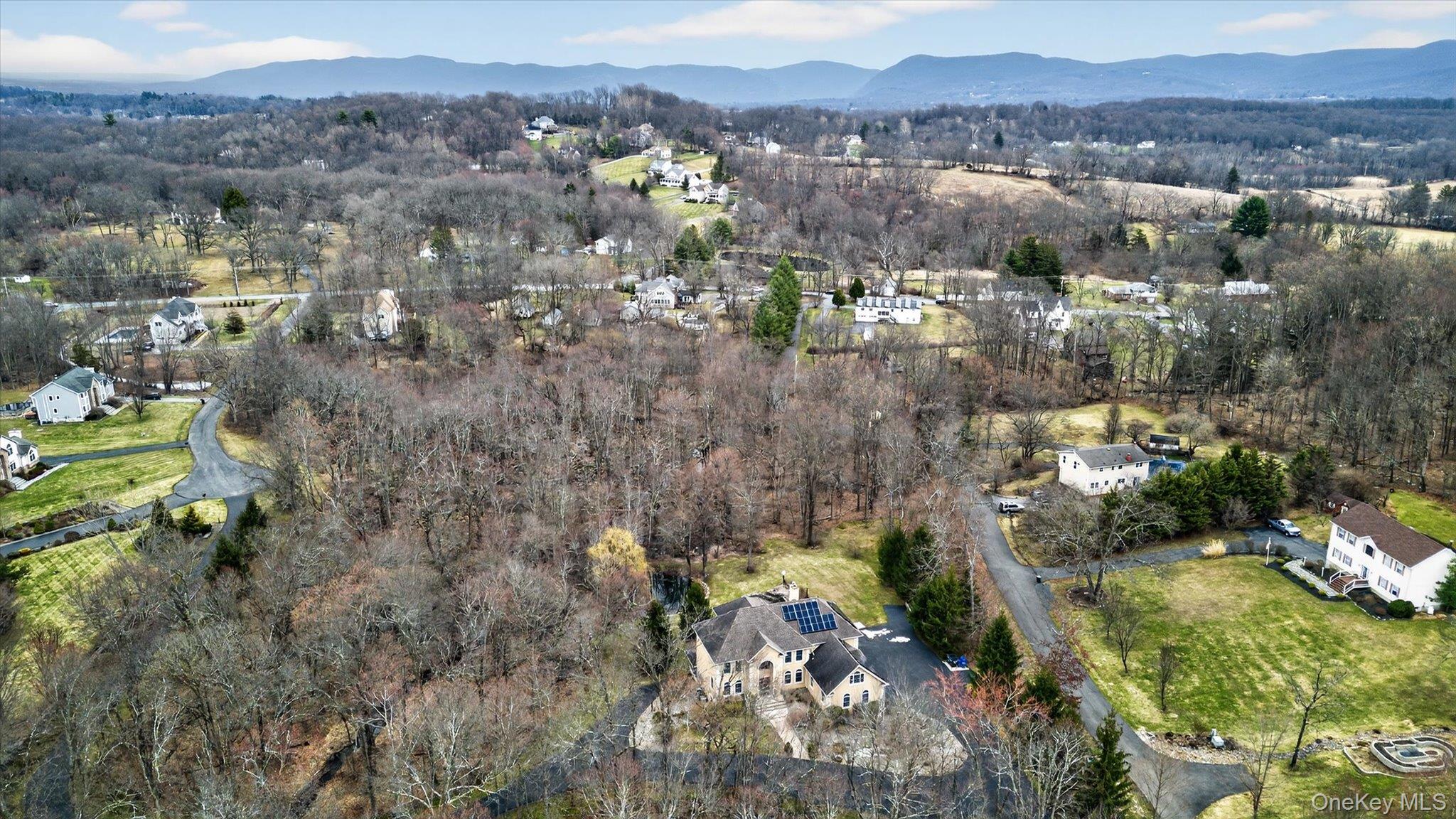 7 Farm Hollow Road New Windsor, NY 12553 - Photo 30 of 36 Aerial overview of property's location with a mountain backdrop and a heavily wooded area