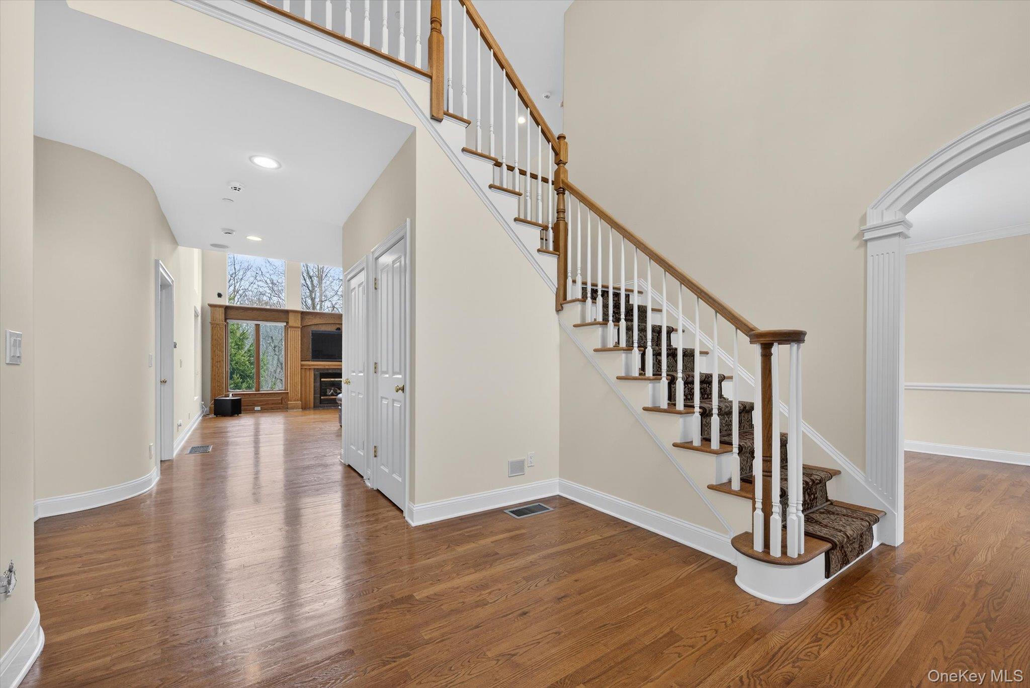 7 Farm Hollow Road New Windsor, NY 12553 - Photo 5 of 36 Staircase featuring a high ceiling, wood finished floors, ornate columns, recessed lighting, and arched walkways