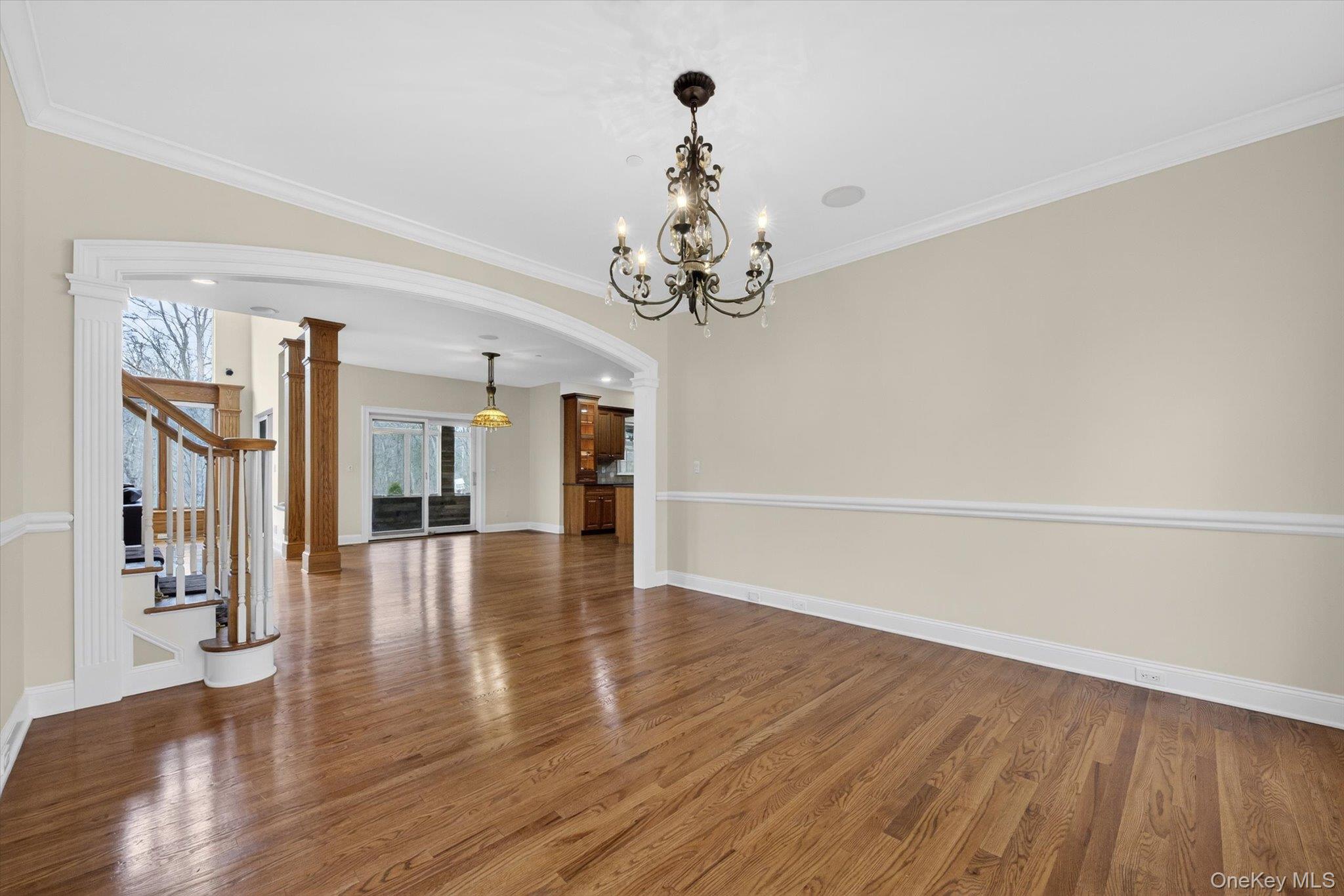 7 Farm Hollow Road New Windsor, NY 12553 - Photo 8 of 36 Unfurnished dining area with arched walkways, dark wood-type flooring, crown molding, and hanging lights