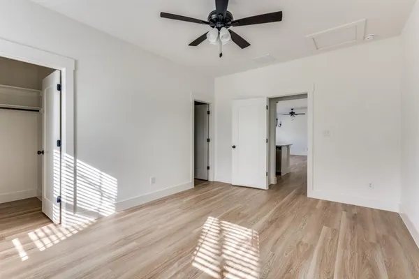 a view of empty room with wooden floor and window