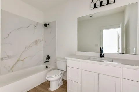 a bathroom with a sink a toilet and a bathtub