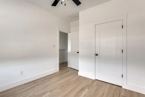 a view of an empty room and wooden floor
