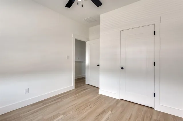 a view of an empty room and wooden floor