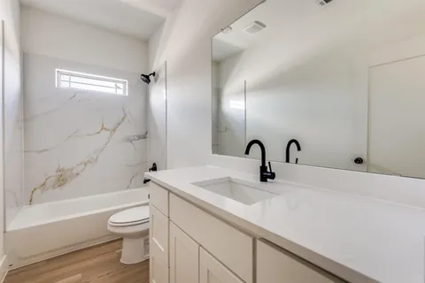a bathroom with a sink a toilet and a bathtub
