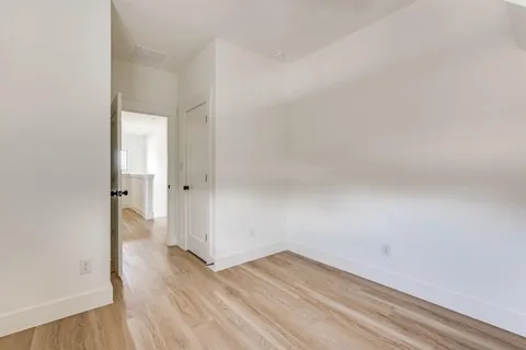 a view of a room with wooden floor