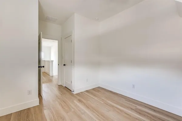 a view of a room with wooden floor