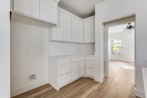a view of cabinets and wooden floor