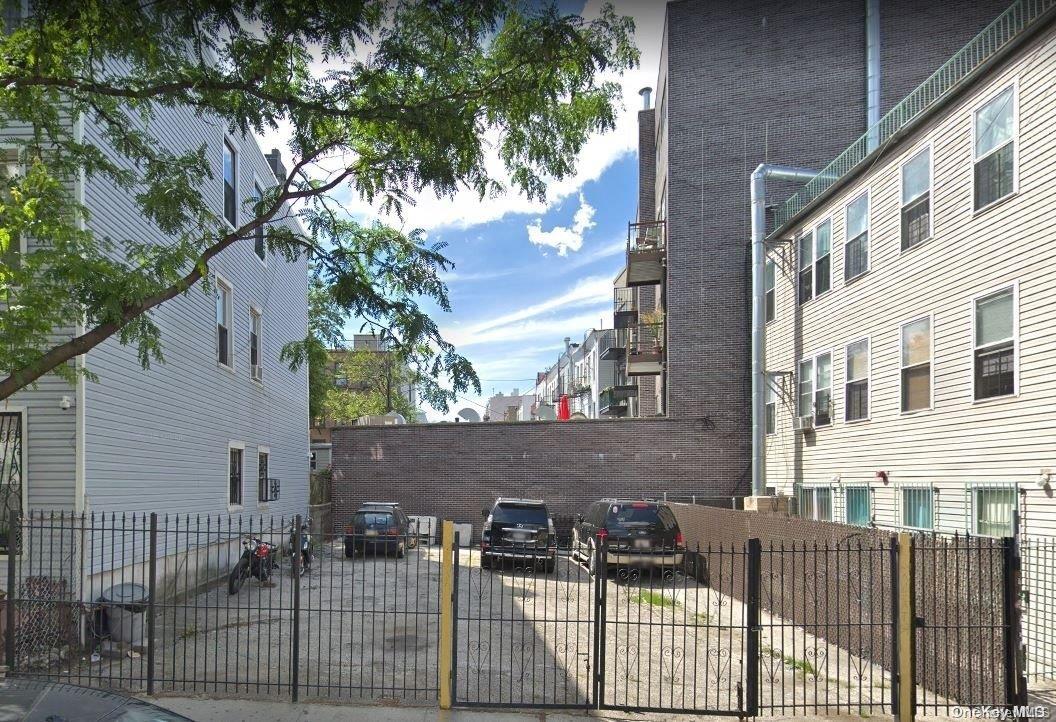 1385 Dekalb Avenue Brooklyn, NY 11221 - Photo 1 of 1 a view of a brick house with a small yard and a large tree