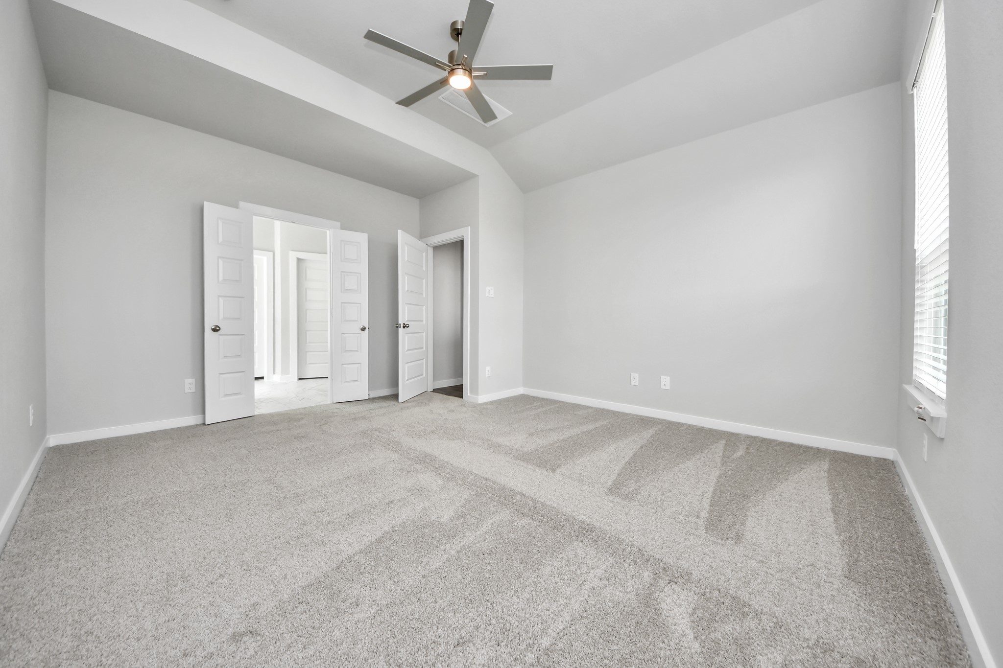11106 Tulip Rdg Trail Houston, TX 77044 - Photo 18 of 34 Come and unwind after a long day in this magnificent primary suite! This spacious room features plush carpet, warm paint, high ceilings and large windows with privacy blinds. Sample photo of completed home with similar floor plan. Actual colors and selections may vary.