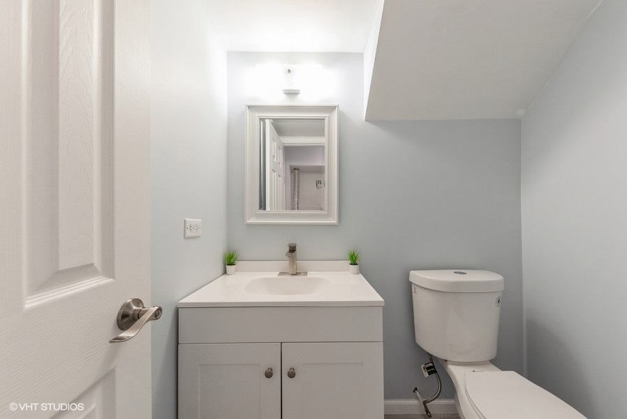 97 Hazelnut Drive Streamwood, IL 60107 - Photo 12 of 14 a bathroom with a toilet sink and mirror