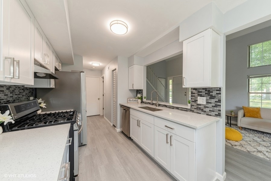 97 Hazelnut Drive Streamwood, IL 60107 - Photo 5 of 14 a kitchen with stainless steel appliances granite countertop a stove and a sink