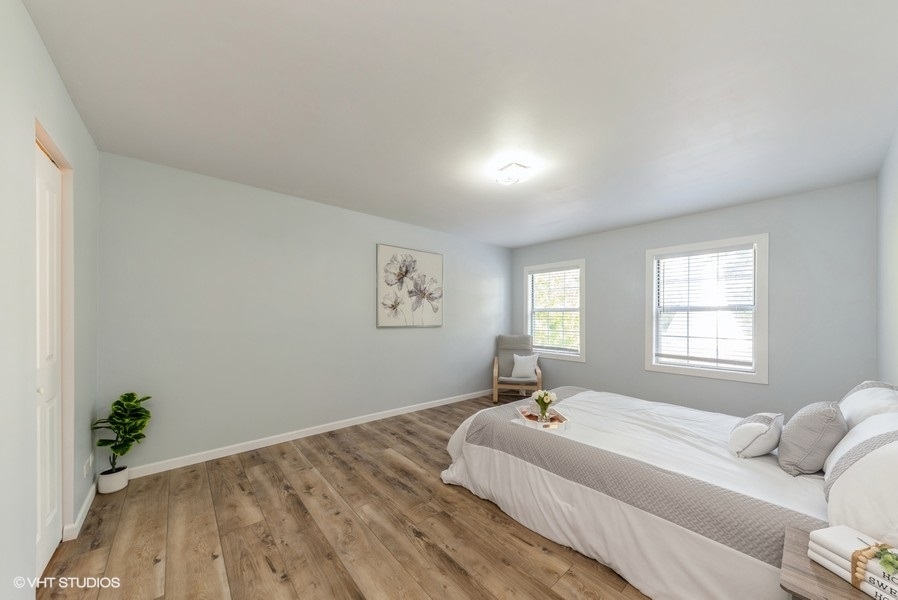 97 Hazelnut Drive Streamwood, IL 60107 - Photo 7 of 14 a spacious bedroom with a bed and a couch