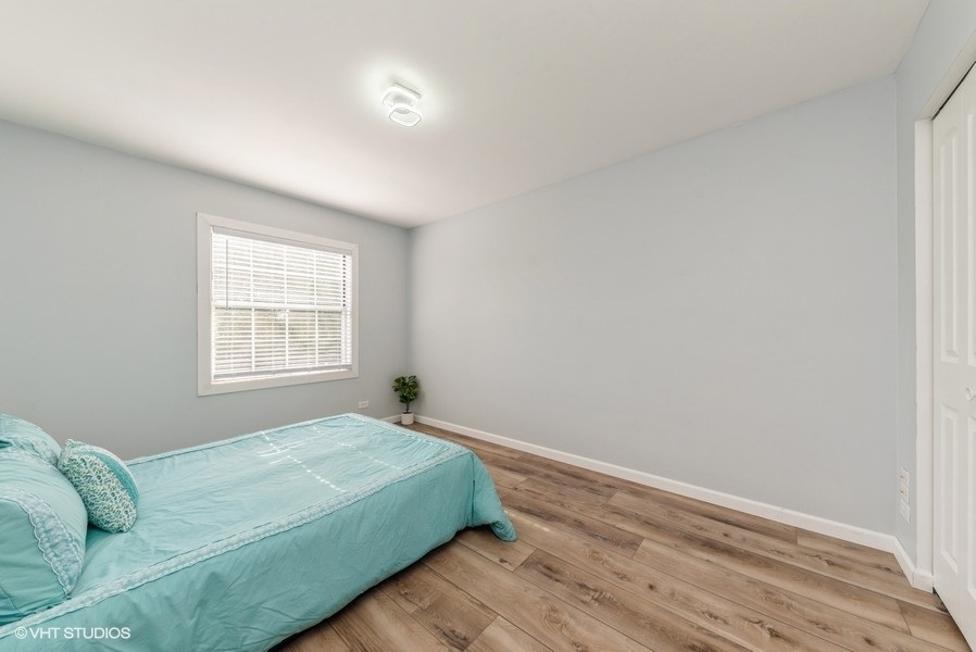 97 Hazelnut Drive Streamwood, IL 60107 - Photo 10 of 14 a bedroom with a bed and a window