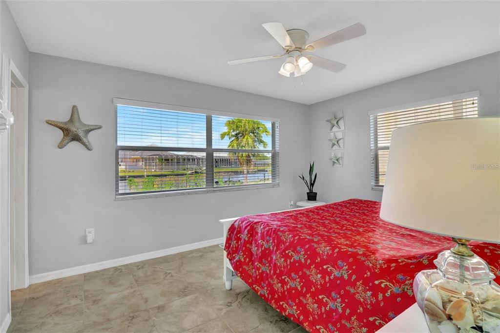 250 Bangsberg Road Southeast Port Charlotte, FL 33952 - Photo 14 of 59 a bedroom with a bed and a window