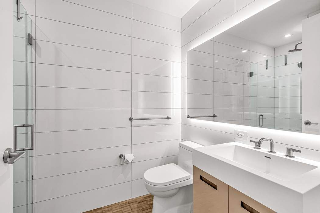98 Front Street, Unit GRD Brooklyn, NY 11201 - Photo 11 of 23 a bathroom with a sink toilet and vanity